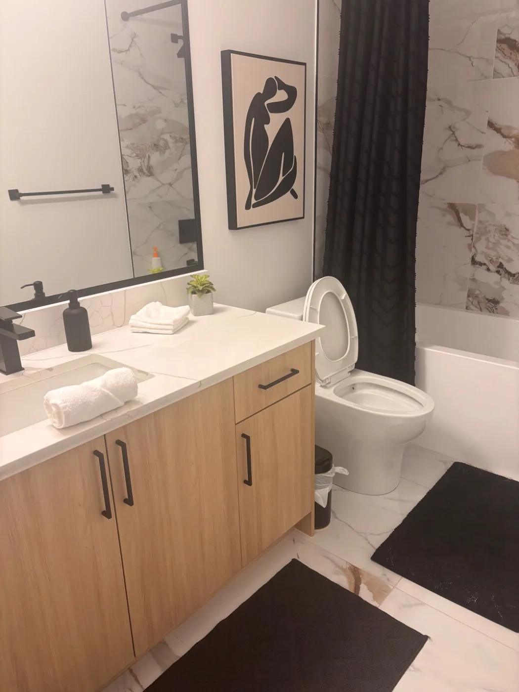 Short term rental bathroom staged with fresh towels after a clean