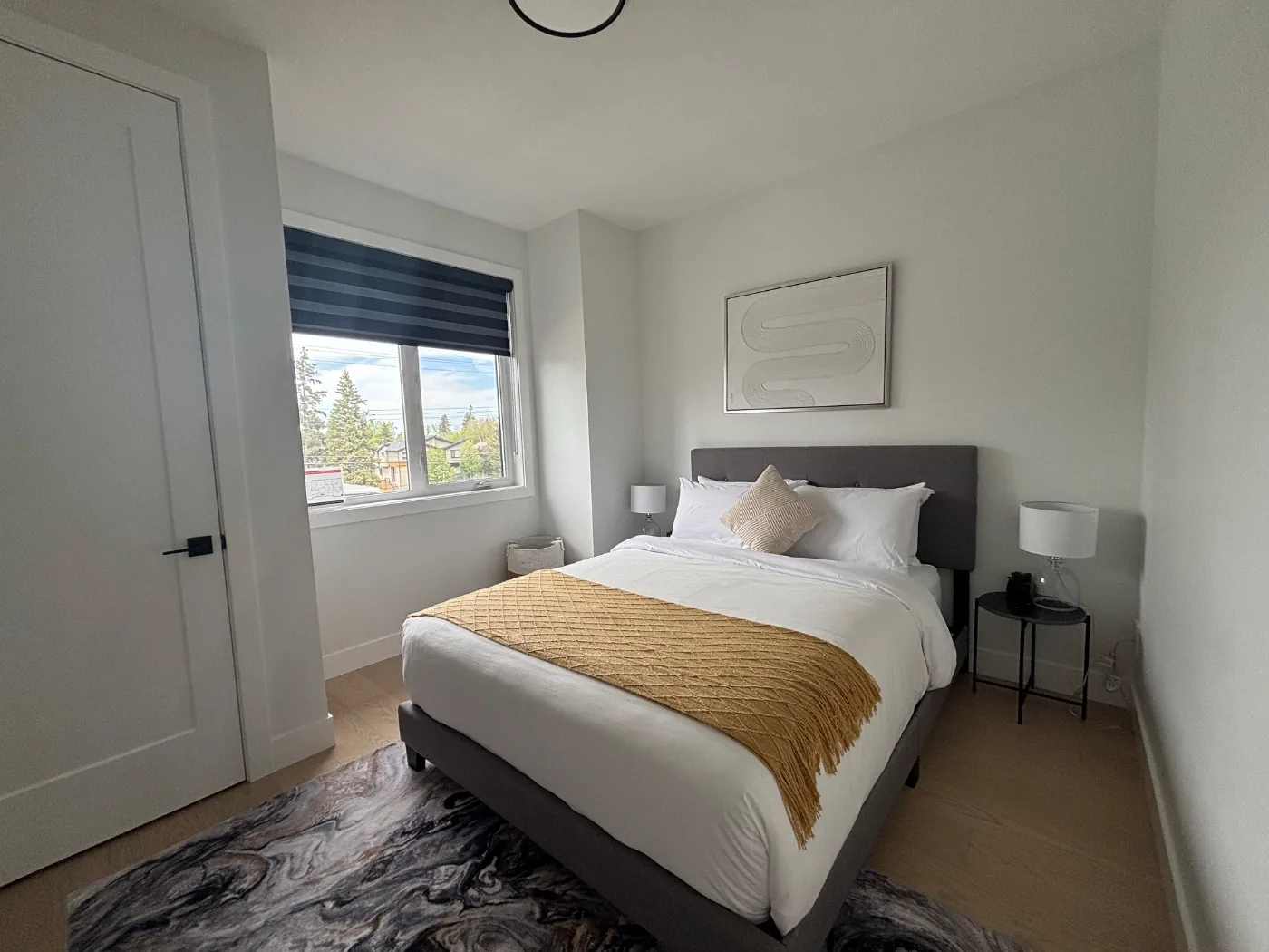 Guest bedroom with a hotel style bed after a short term rental clean