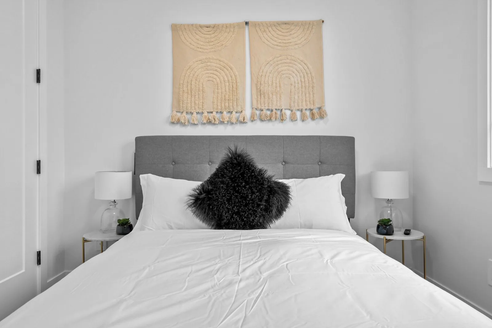 Guest bedroom with fresh white linens and bedside lamps