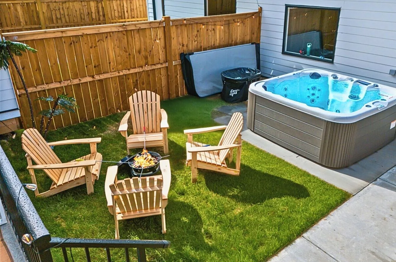 Backyard hot tub and firepit at a Calgary short term rental