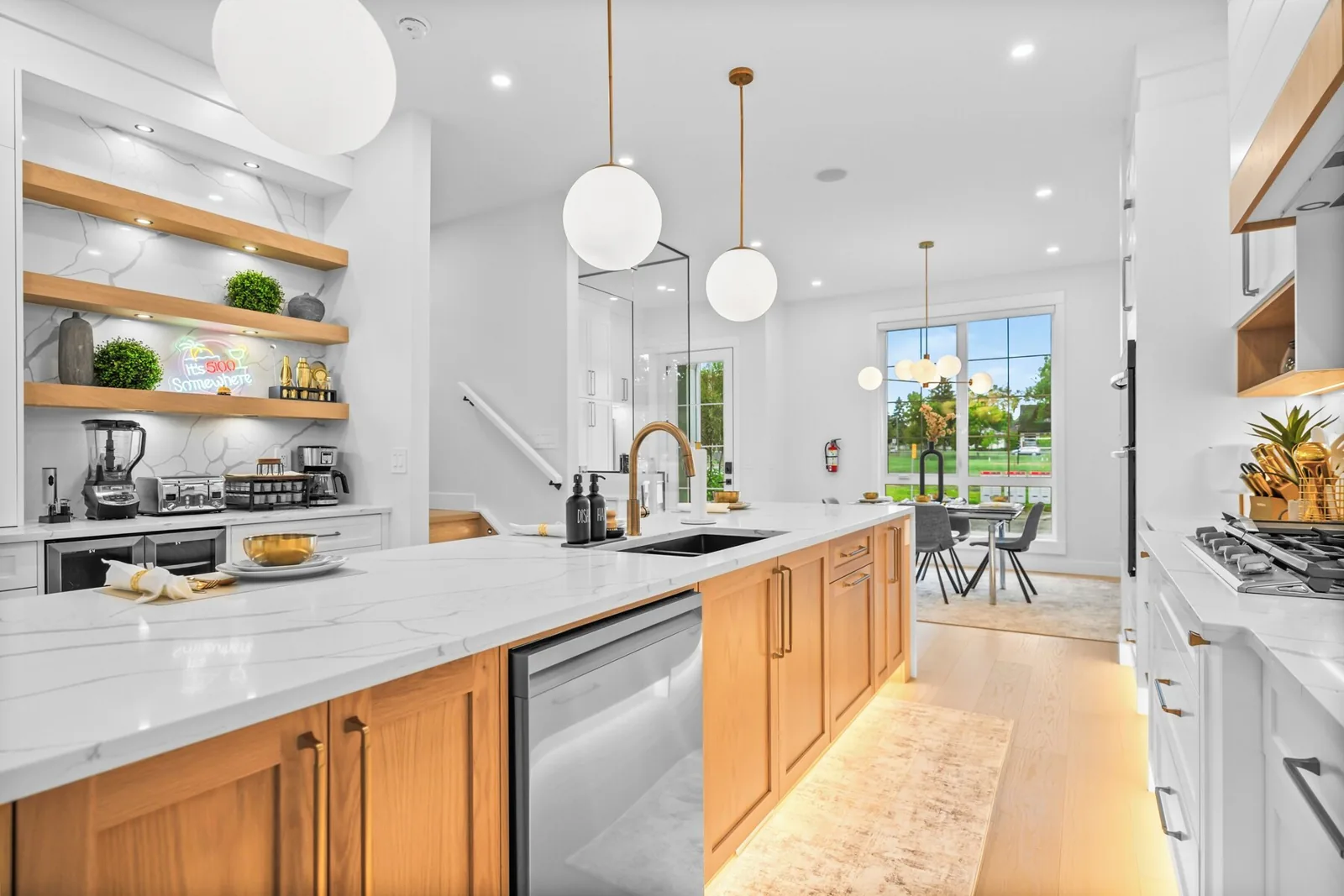 Bright kitchen with quartz island reset between guests