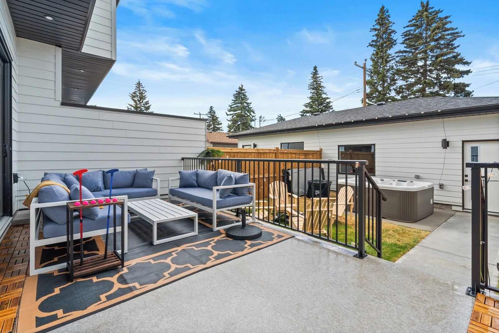 Back patio and hot tub at a Calgary short term rental during peak season
