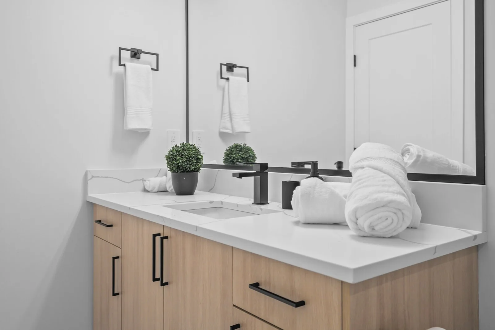 Bathroom vanity with rolled towels staged for the next guest