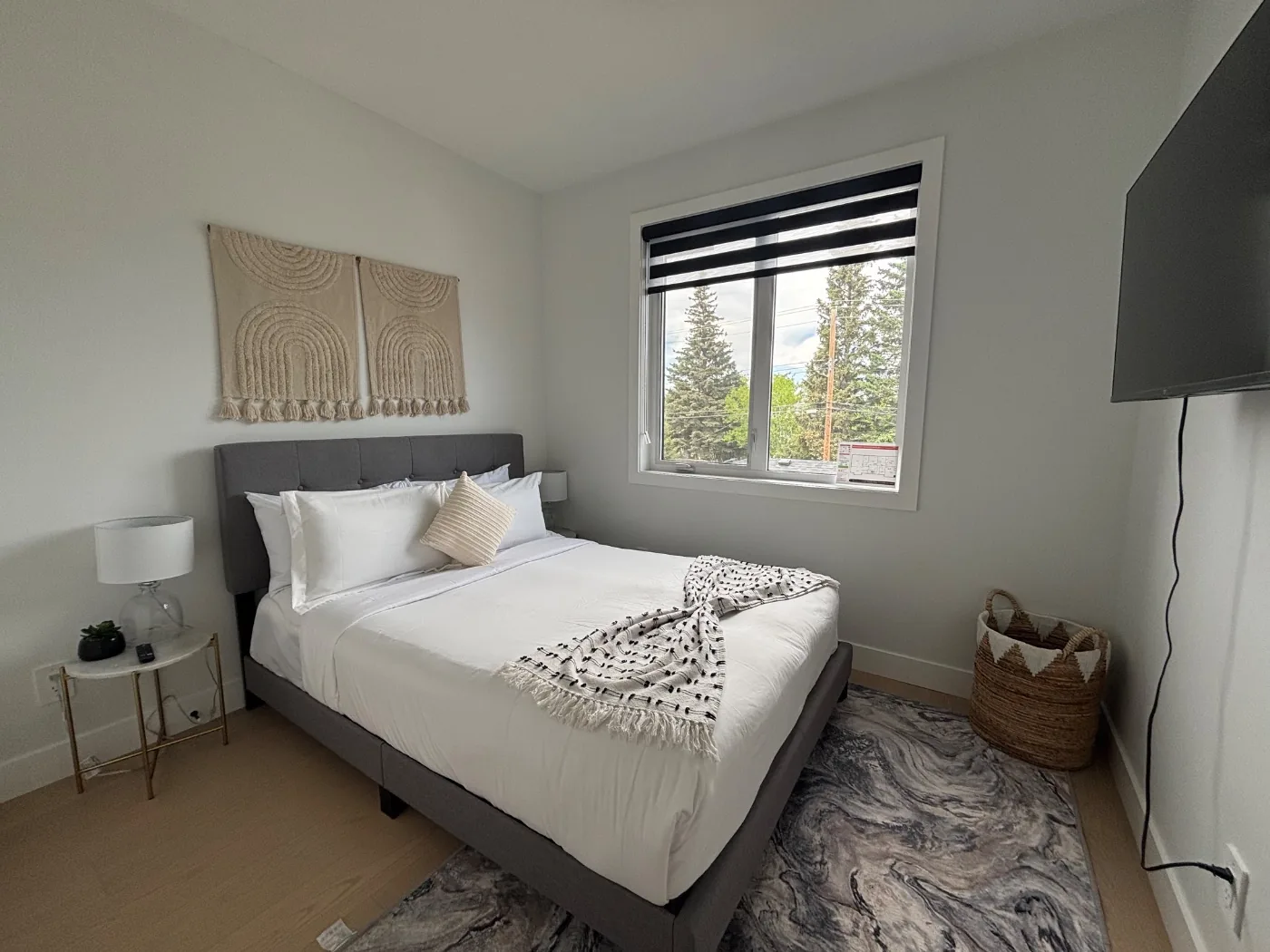 Vacation rental bedroom with a made bed and clear surfaces